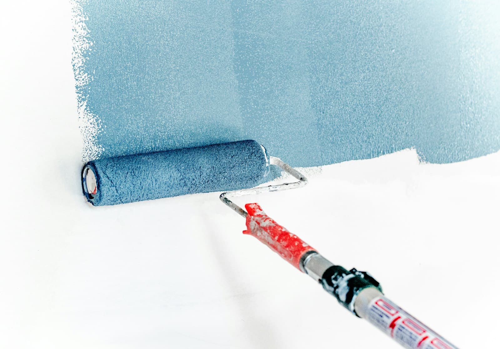 Fresh paint being rolled onto an interior wall