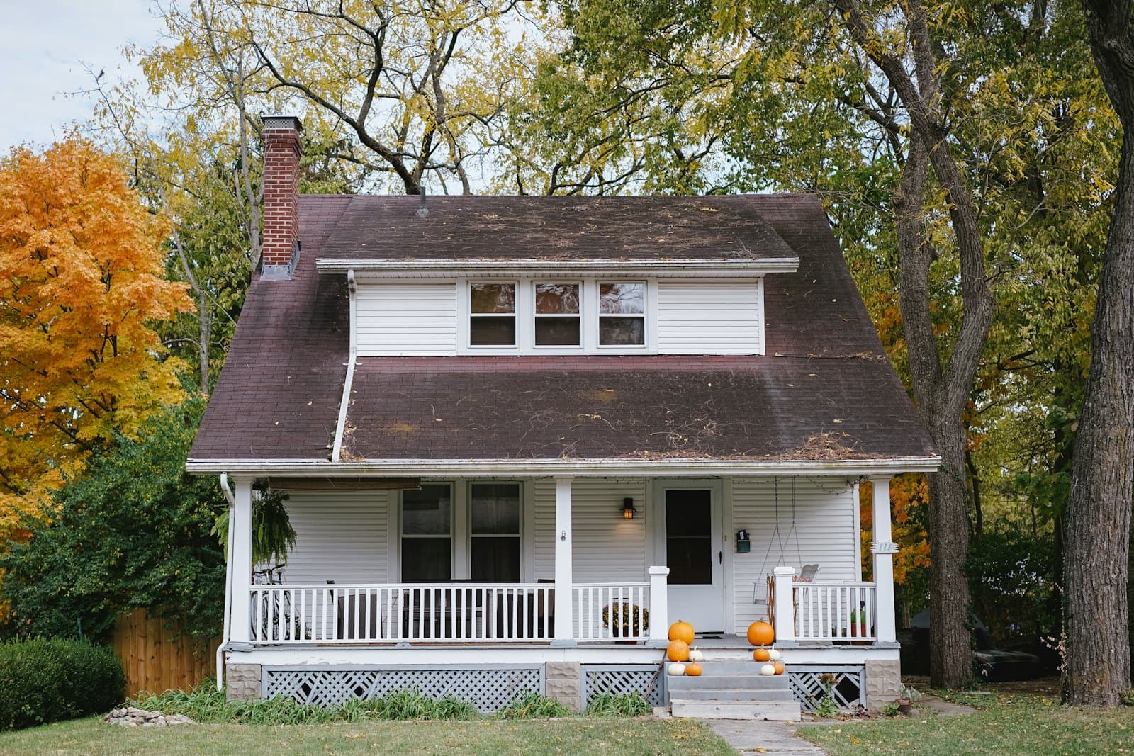 White weatherboard cottage with a painted porch