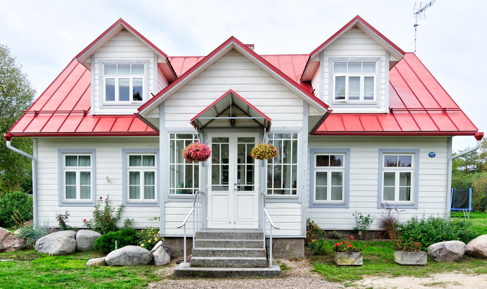 Freshly painted heritage weatherboard home with red roof